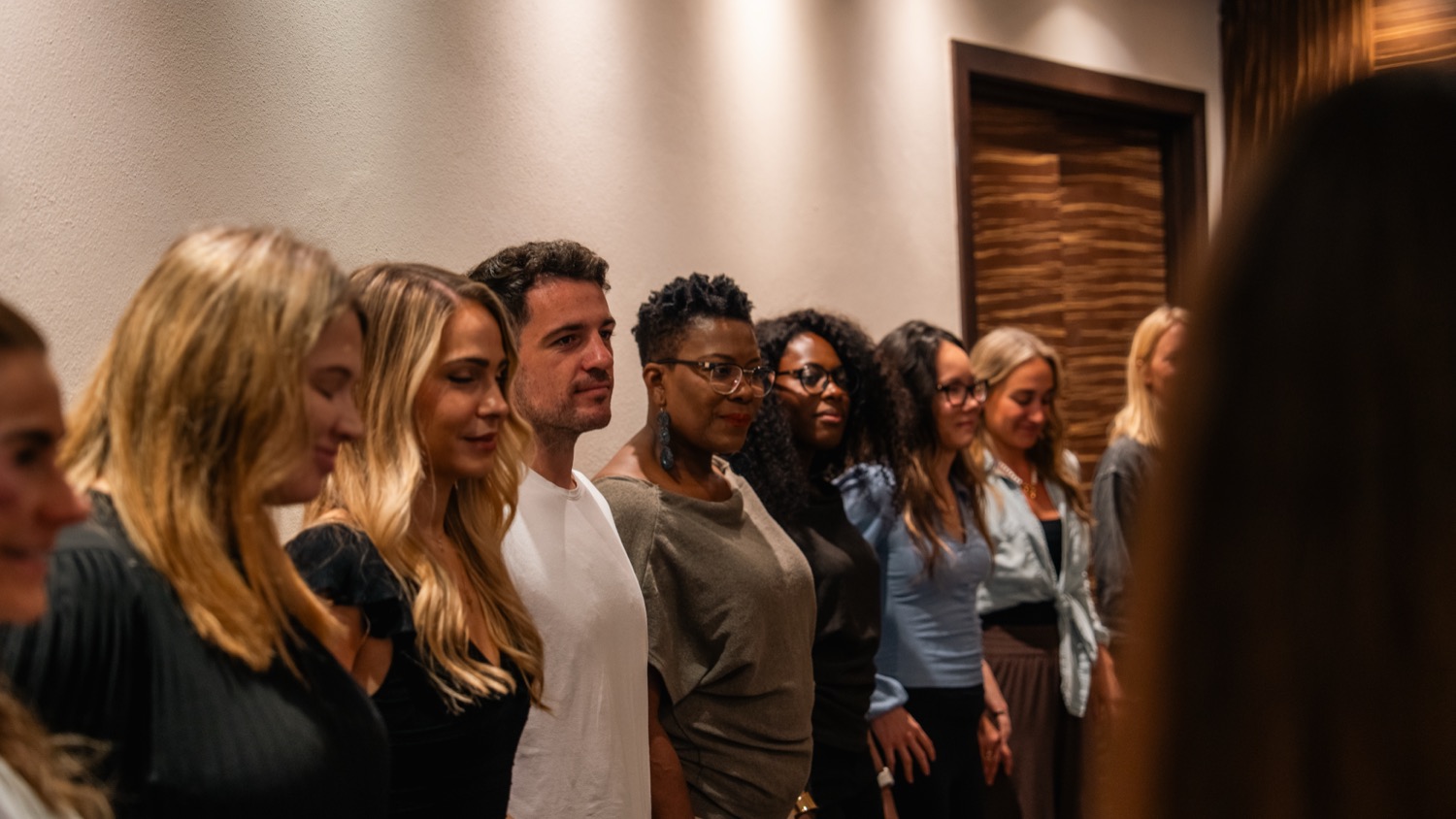 A line of women standing together at the front of the room